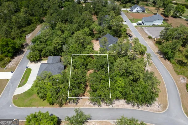 an aerial view of residential house with outdoor space and swimming pool