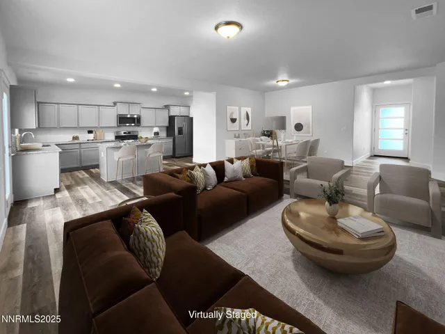 a living room with furniture and a view of kitchen