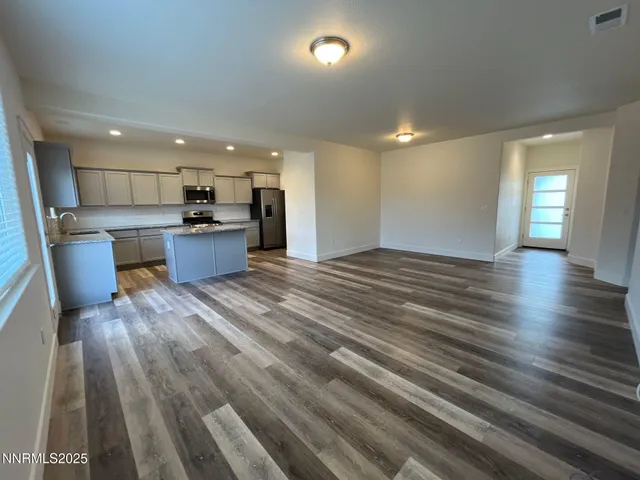 a view of kitchen with sink microwave and refrigerator