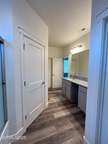 a large bathroom with a sink and a large mirror