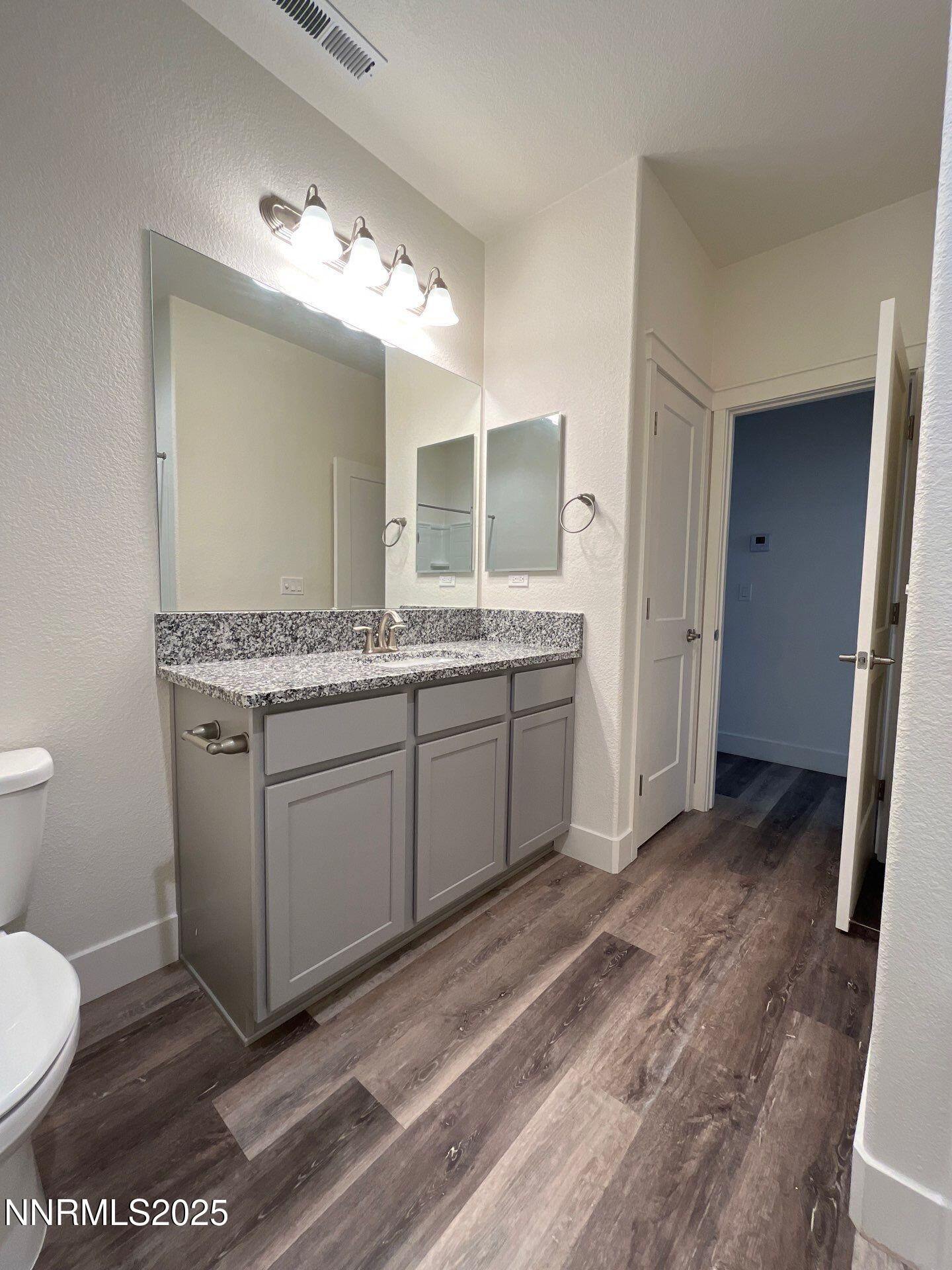 1160 Church Peak Court Reno, NV 89508 - Photo 10 of 17 a spacious bathroom with a granite countertop sink and a mirror