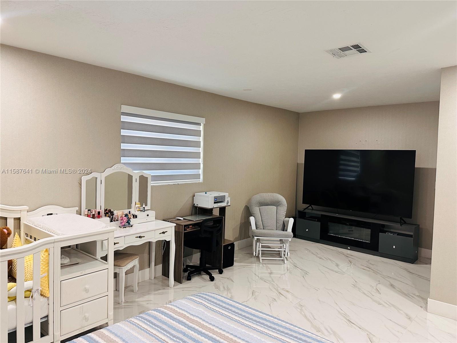 17841 Southwest 113th Avenue Miami, FL 33157 - Photo 11 of 23 a living room with furniture and a flat screen tv