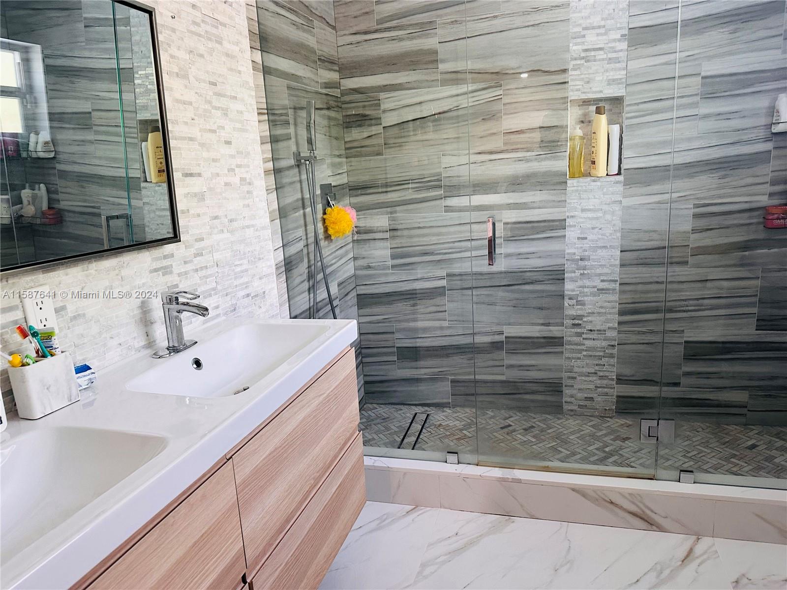 17841 Southwest 113th Avenue Miami, FL 33157 - Photo 13 of 23 a bathroom with a sink and a mirror