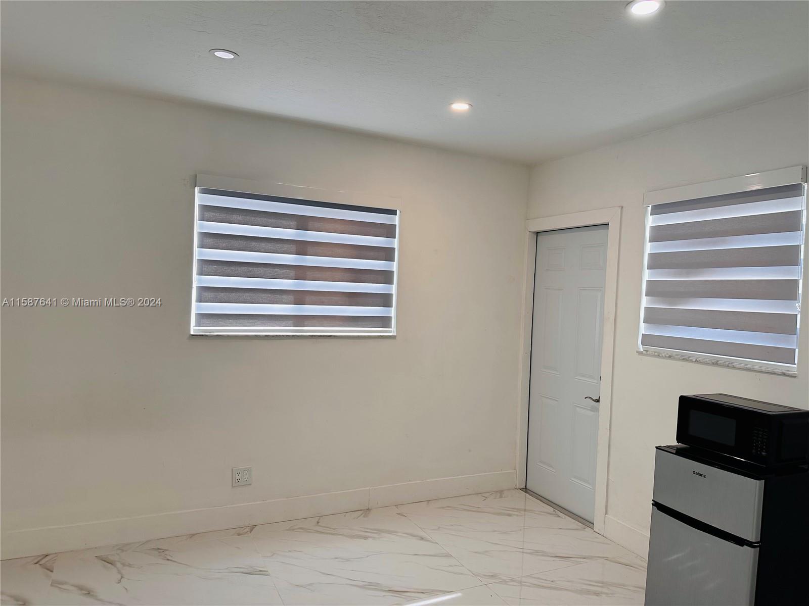 17841 Southwest 113th Avenue Miami, FL 33157 - Photo 22 of 23 a view of empty room with kitchen and window