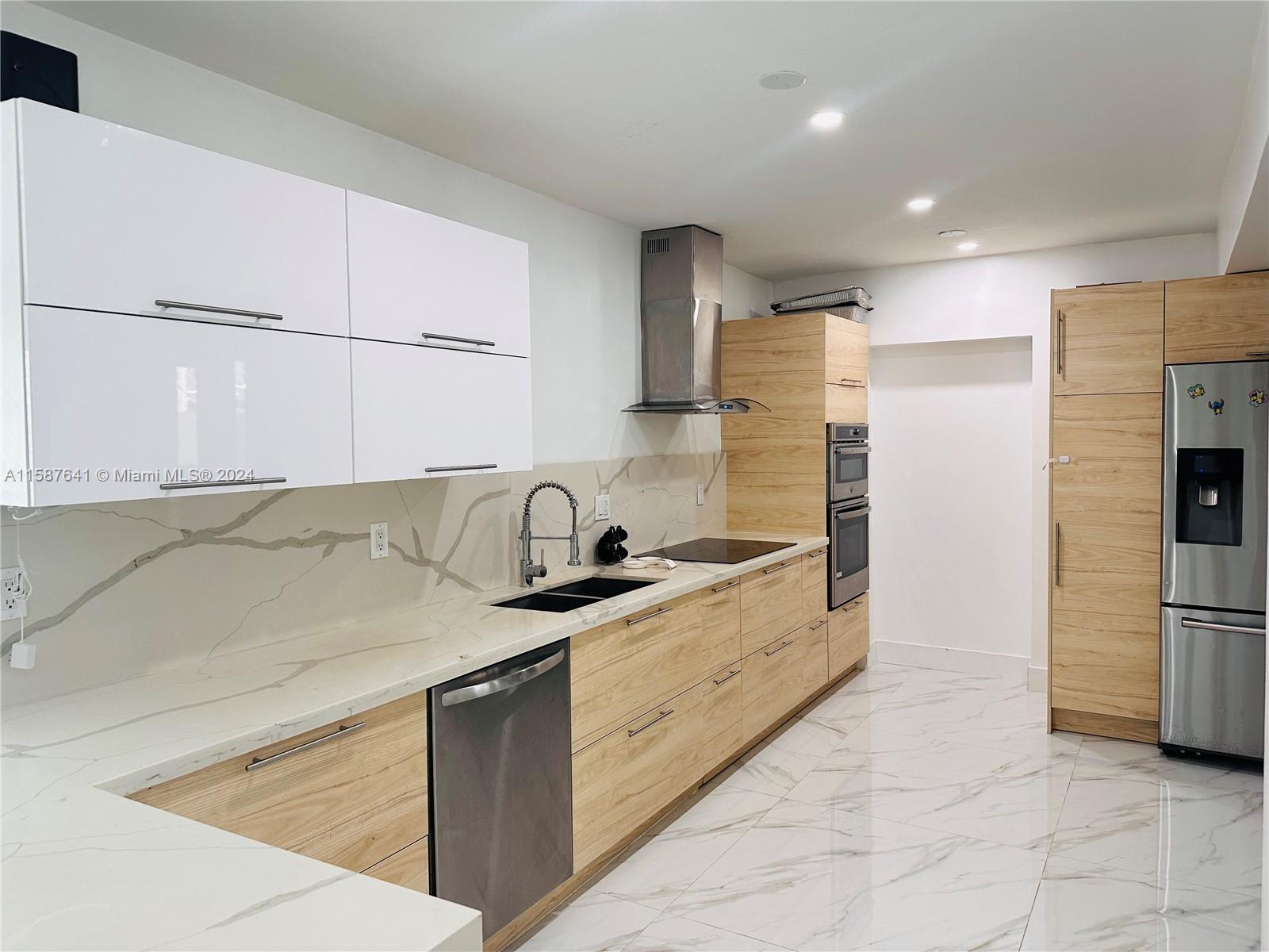 17841 Southwest 113th Avenue Miami, FL 33157 - Photo 6 of 23 a kitchen with stainless steel appliances granite countertop a sink and a refrigerator