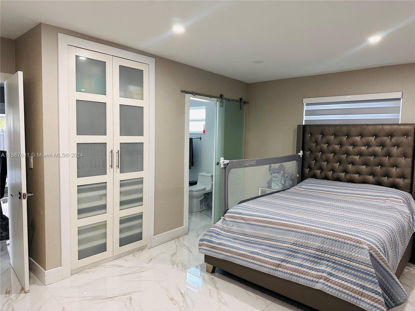 17841 Southwest 113th Avenue Miami, FL 33157 - Photo 9 of 23 a bedroom with a bed and a closet