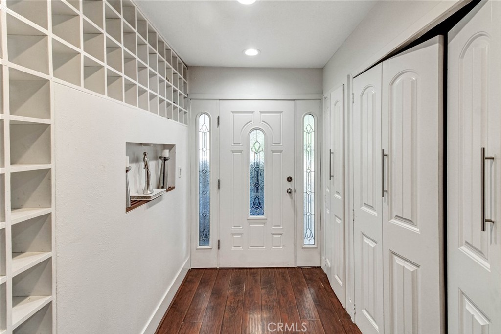 1025 South Riverside Avenue, Unit 26 Rialto, CA 92376 - Photo 7 of 27 a view of a hallway with wooden floor and entryway
