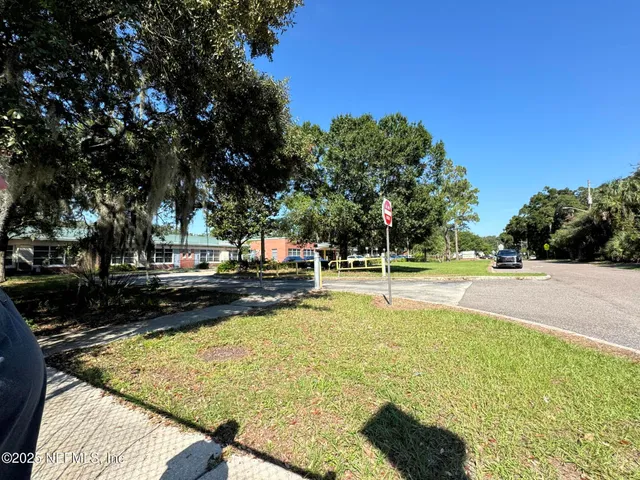 a view of a swimming pool with an outdoor seating and a yard