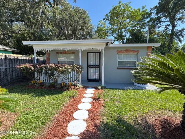 a front view of house with yard and outdoor seating