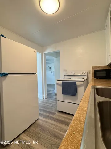 a kitchen with a refrigerator and a stove