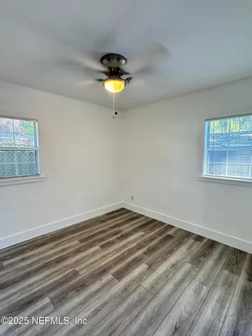 a view of a room with a wooden floor and a sink