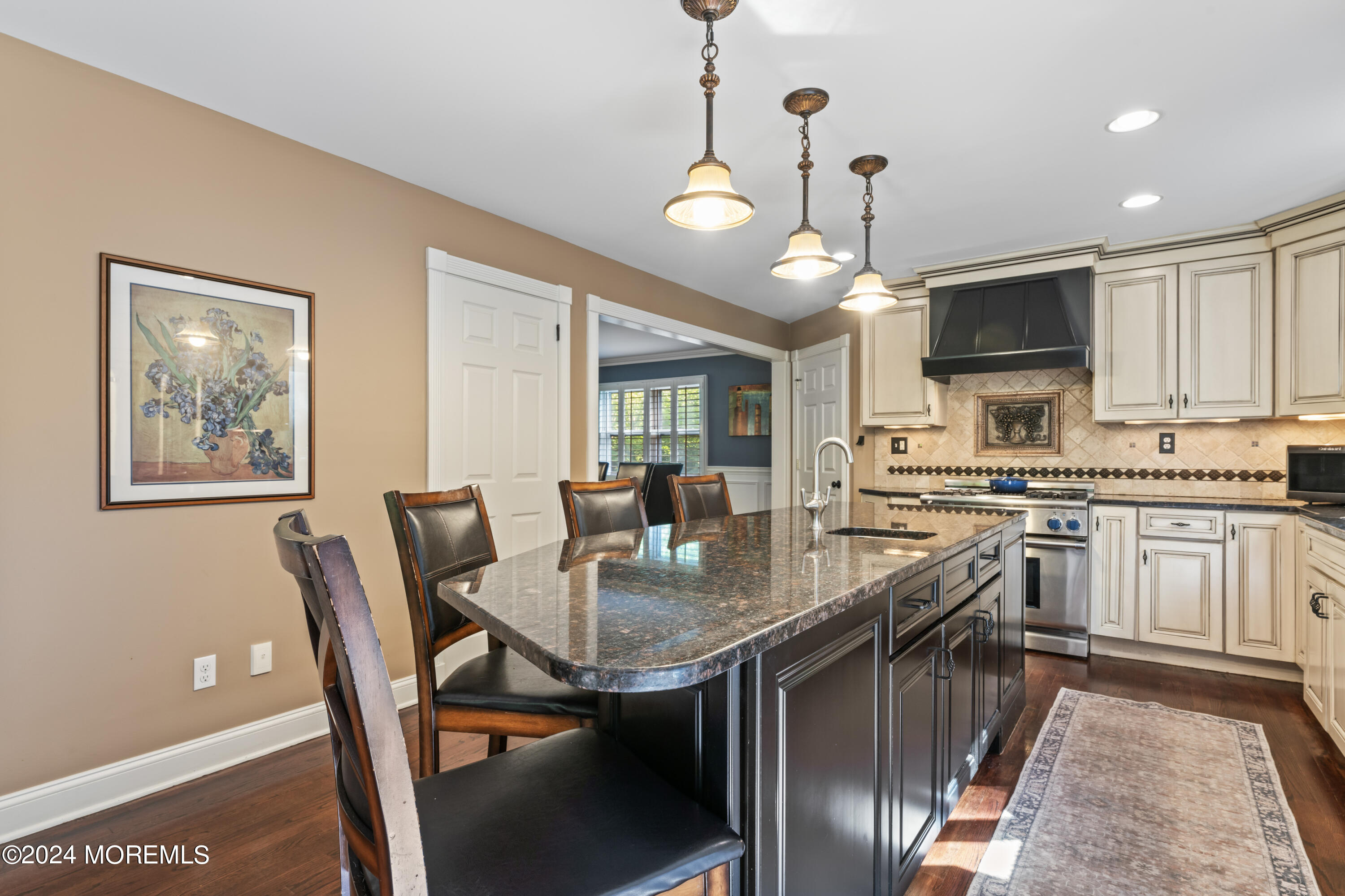 54 Rutherford Road Berkeley Heights, NJ 07922 - Photo 11 of 43 a kitchen with stainless steel appliances granite countertop a stove top oven a sink dishwasher a dining table and chairs with wooden floor