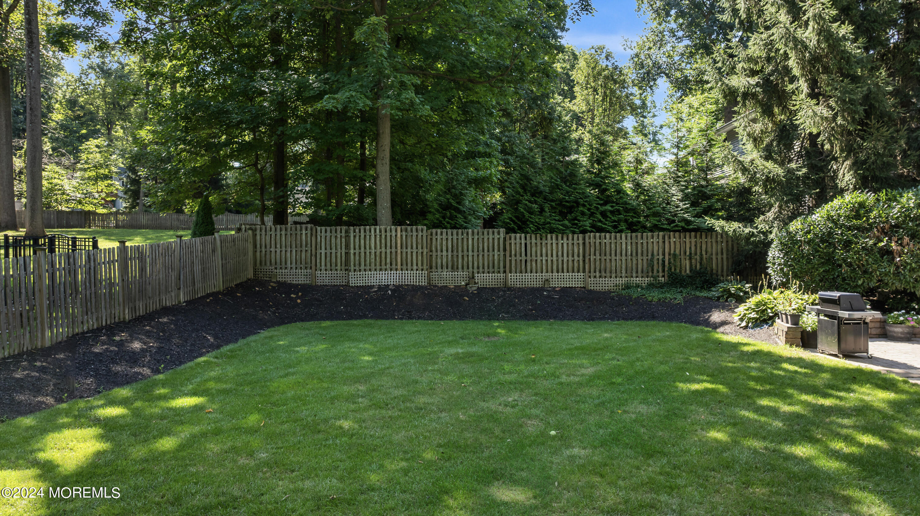 54 Rutherford Road Berkeley Heights, NJ 07922 - Photo 35 of 43 a view of a yard with a fence and trees