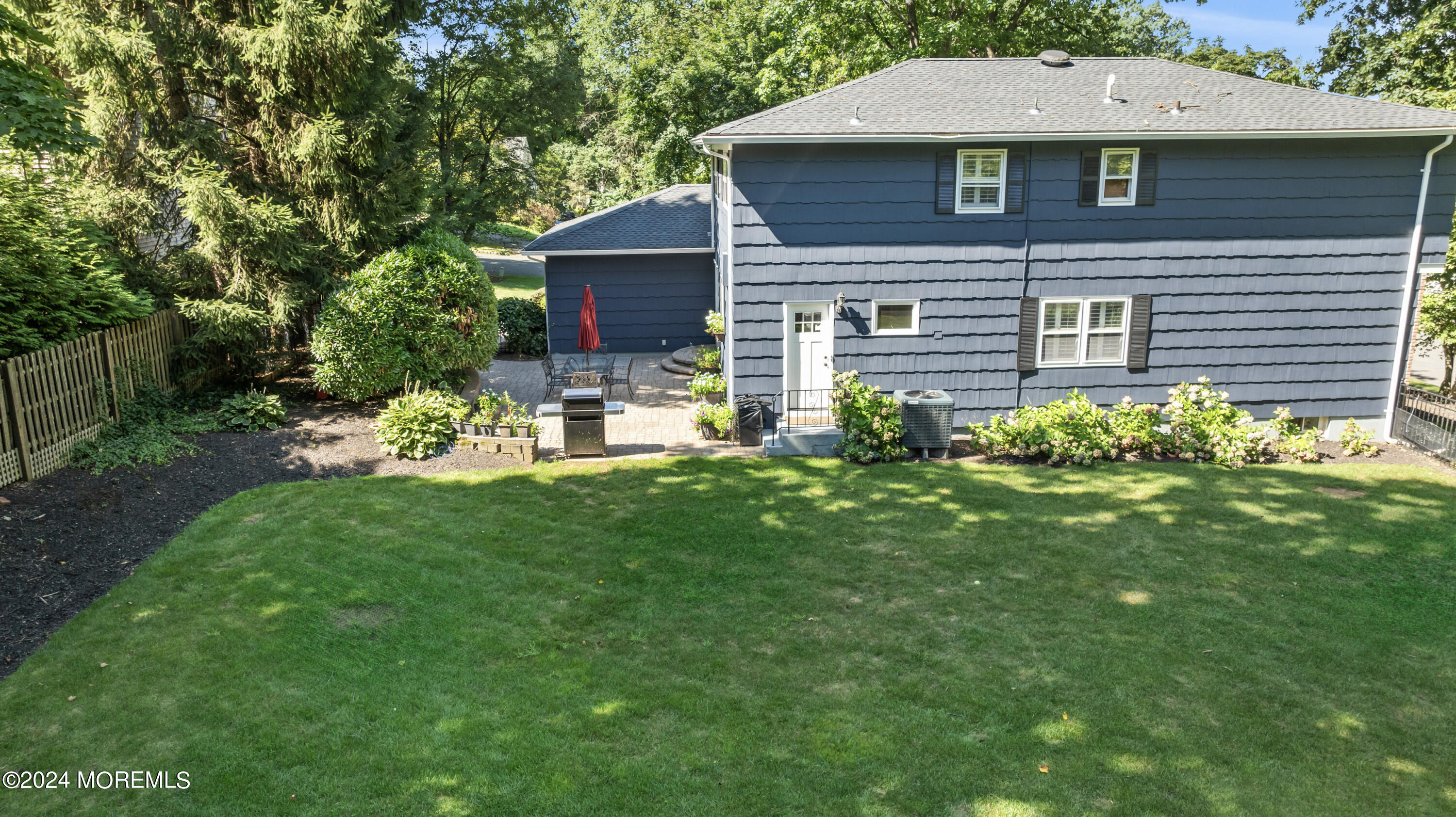 54 Rutherford Road Berkeley Heights, NJ 07922 - Photo 38 of 43 a front view of a house with a yard and table and chairs