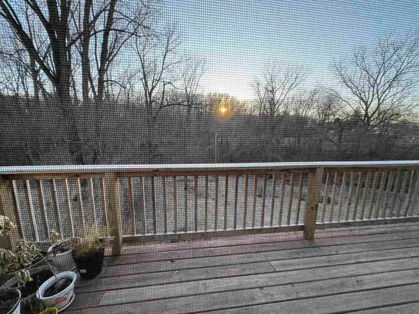 a balcony with wooden floor and fence