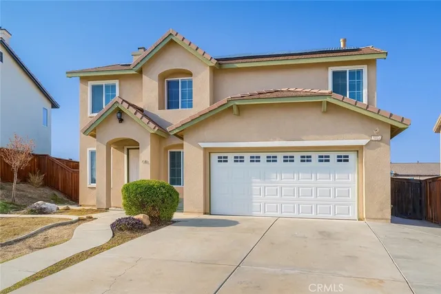 a view of a house with a yard and garage