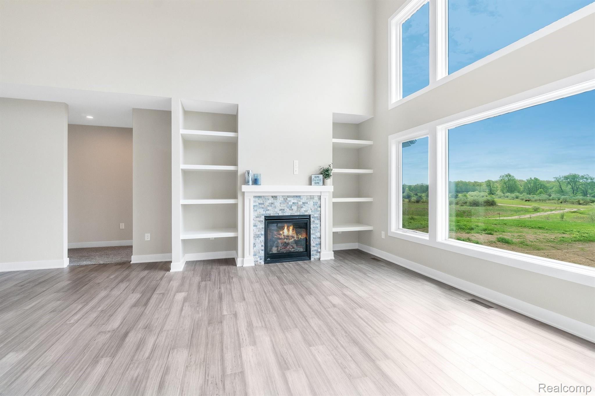 12240 Hibner Road Hartland, MI 48353 - Photo 7 of 37 Great room with fire place and built-in shelves