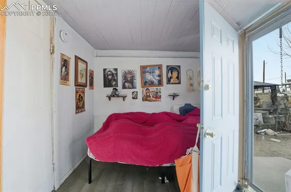 a bed room with a bed and a painting on the wall
