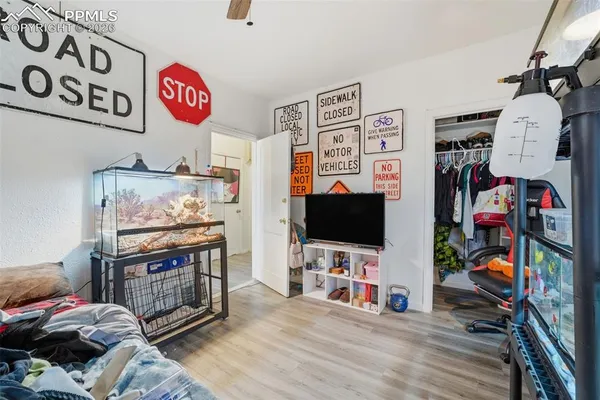 a bedroom with furniture and a flat screen tv