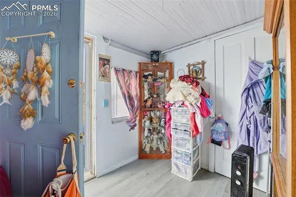 a view of an entryway with wooden shelves