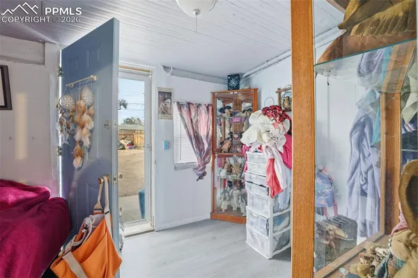 a view of walk in closet with clothes