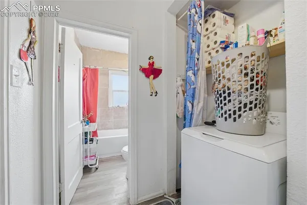a bathroom with a toilet and a shower curtain