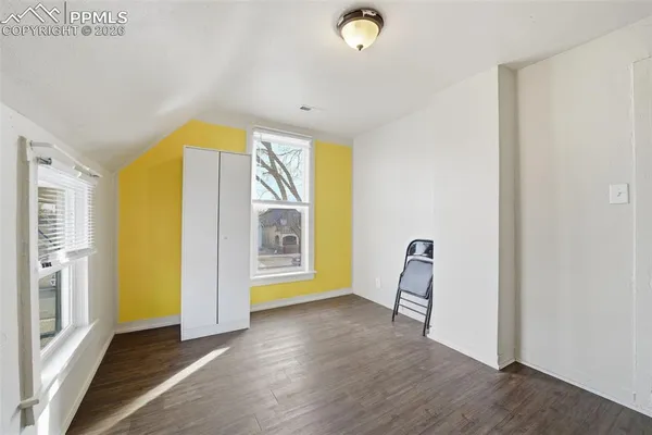 a view of room with window and wooden floor