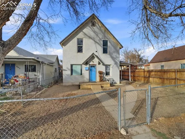 a view of a house with wooden fence
