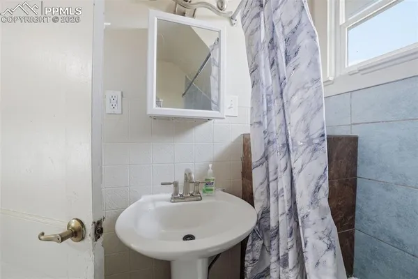 a bathroom with a sink and mirror
