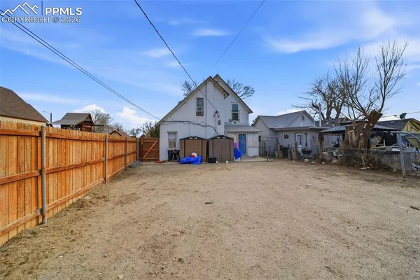 a front view of a house with wooden fence