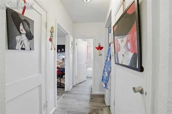 a view of a hallway with paintings on the wall and paintings on the wall