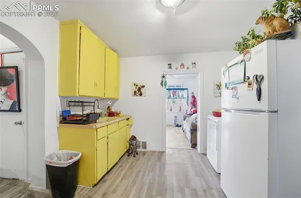a kitchen with a refrigerator and a stove