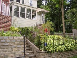 a view of a pathway of a house with flower garden