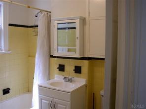 5517 Fieldston Road Bronx, NY 10471 - Photo 5 of 7 a bathroom with a sink and a mirror