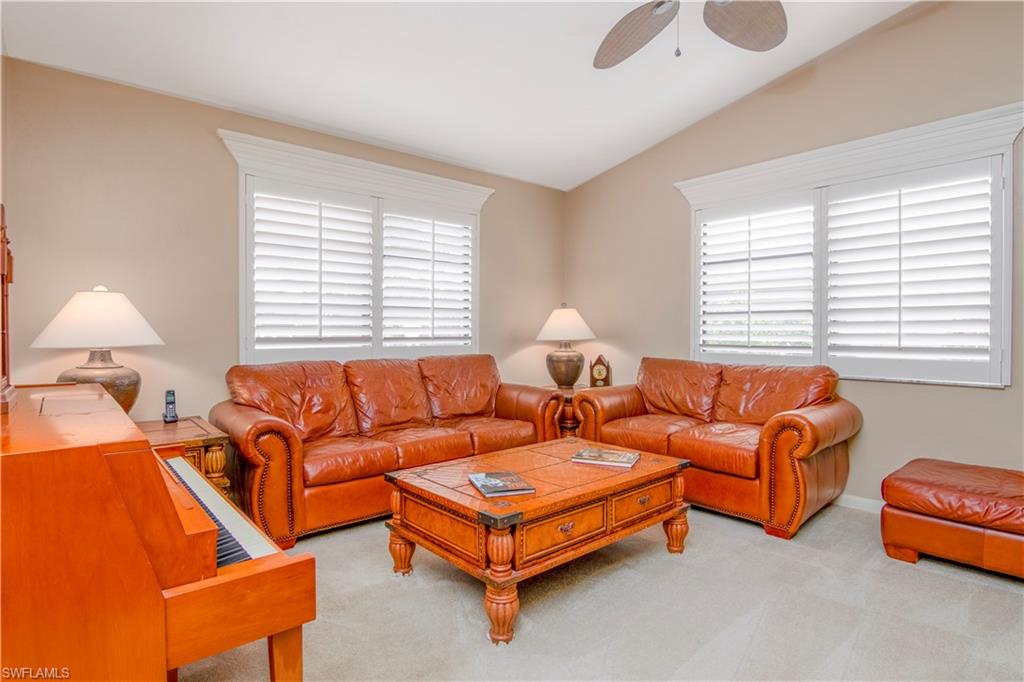 214 Torrey Pines Point Naples, FL 34113 - Photo 8 of 30 a living room with furniture and a large window