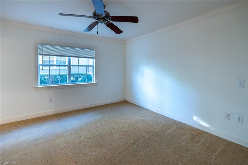 1362 Centre Ct Ridge Drive, Unit 101 Reunion, FL 34747 - Photo 10 of 25 Spare room featuring ornamental molding, carpet floors, and ceiling fan