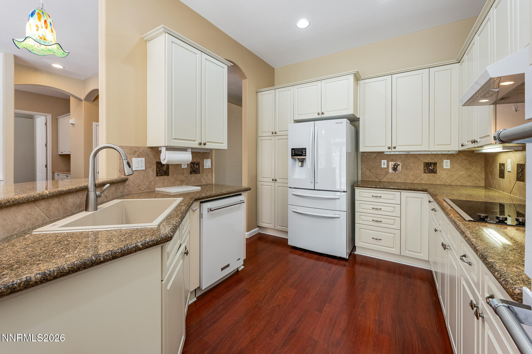 1840 Hunter Creek Road Reno, NV 89519 - Photo 6 of 39 a kitchen with granite countertop a sink stove and refrigerator