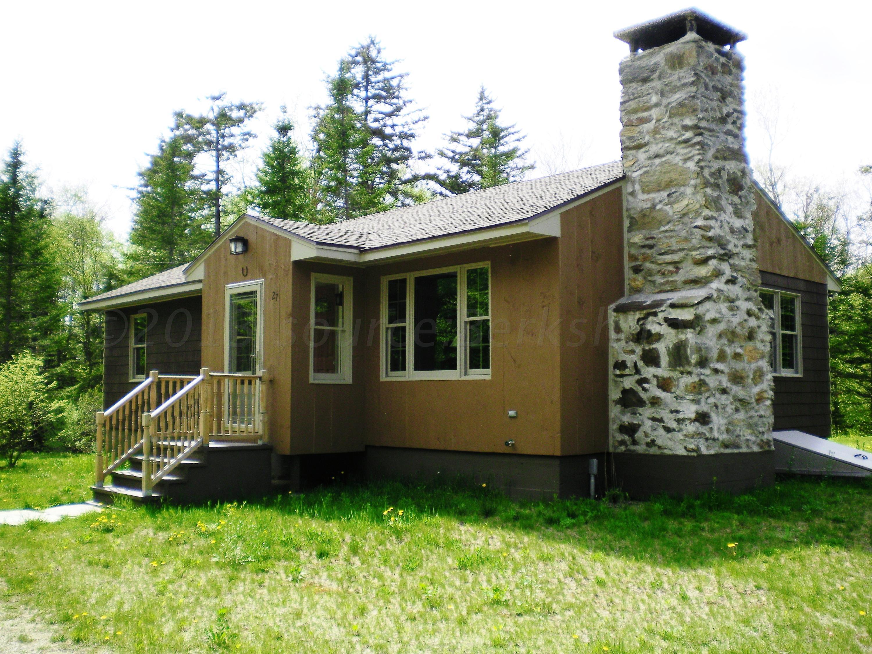a view of a house with a backyard
