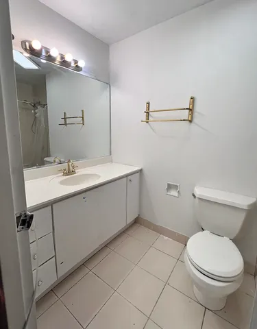 a bathroom with a sink a toilet and mirror