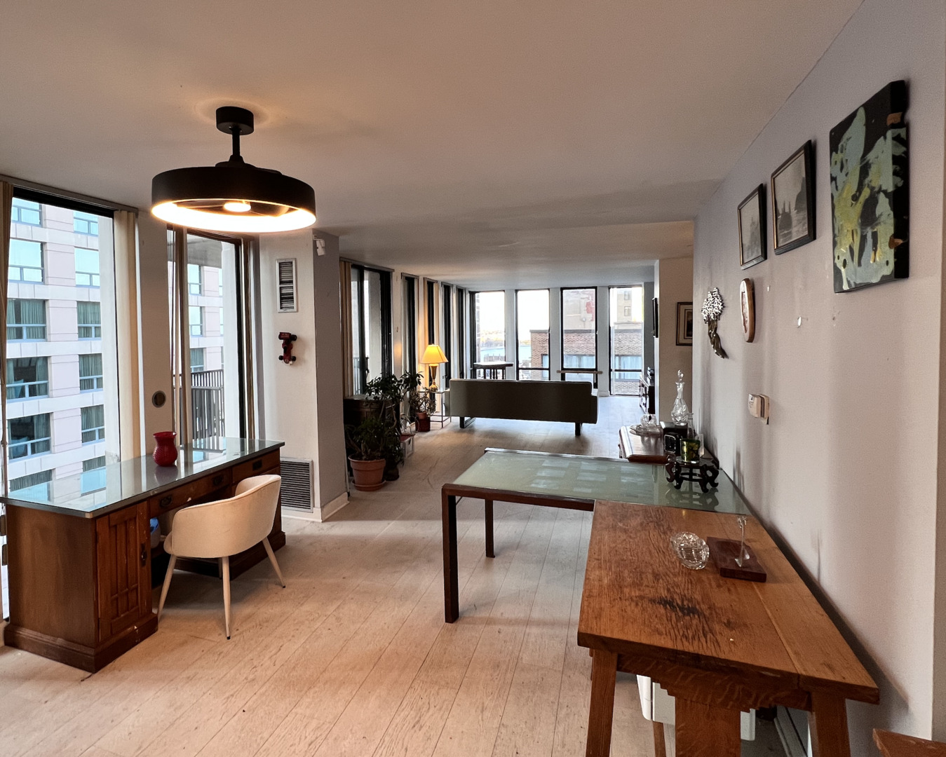 200 East Delaware Place, Unit 19A Chicago, IL 60611 - Photo 3 of 15 a living room with furniture and a chandelier