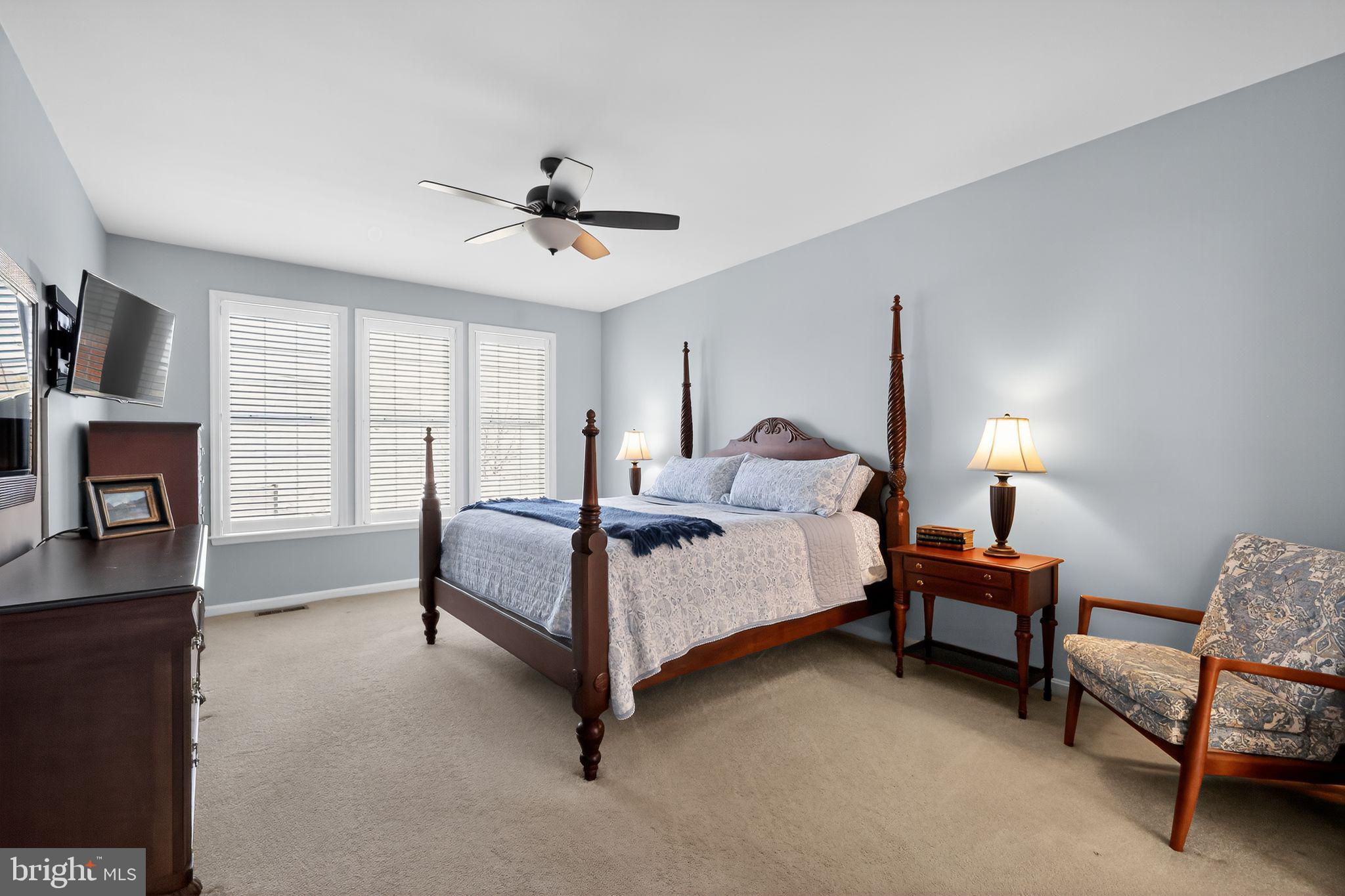 6013 Piney Grove Way Gainesville, VA 20155 - Photo 13 of 41 a spacious bedroom with a bed and a chandelier