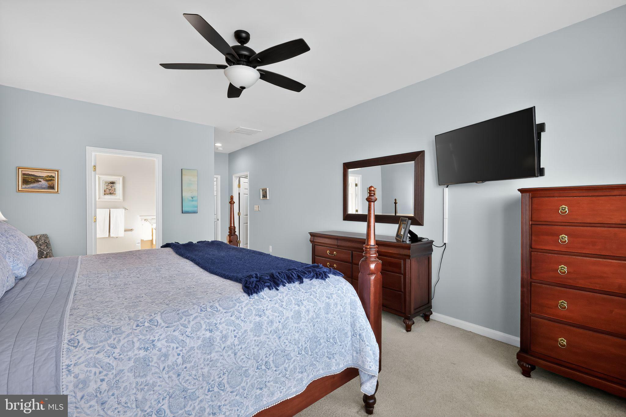 6013 Piney Grove Way Gainesville, VA 20155 - Photo 14 of 41 a bedroom with a bed and a flat screen tv