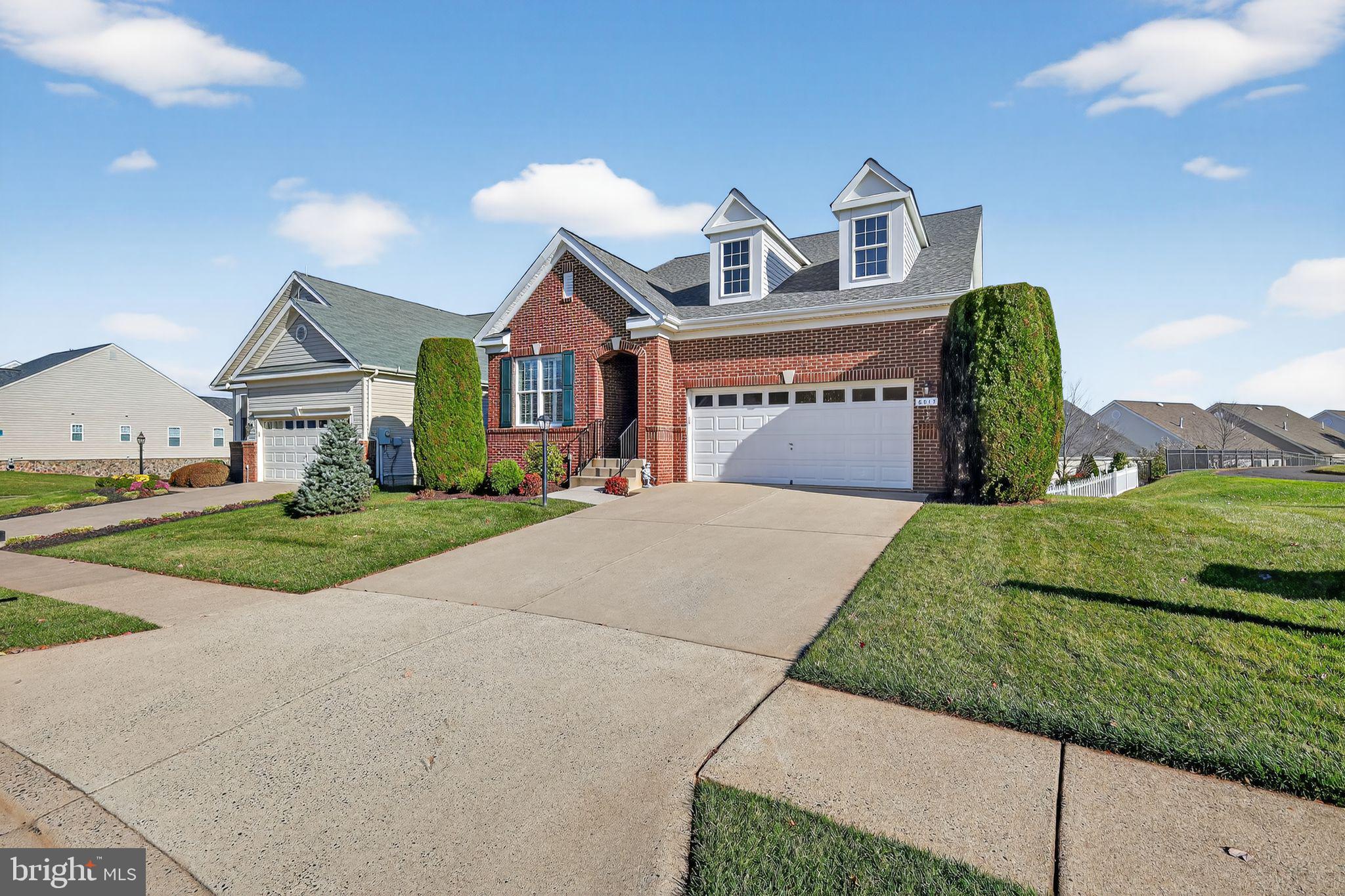 6013 Piney Grove Way Gainesville, VA 20155 - Photo 2 of 41 a front view of a house with garden