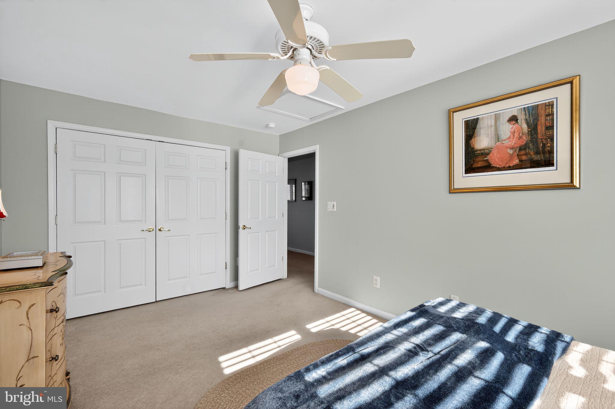 6013 Piney Grove Way Gainesville, VA 20155 - Photo 23 of 41 a bedroom with a bed and a chandelier
