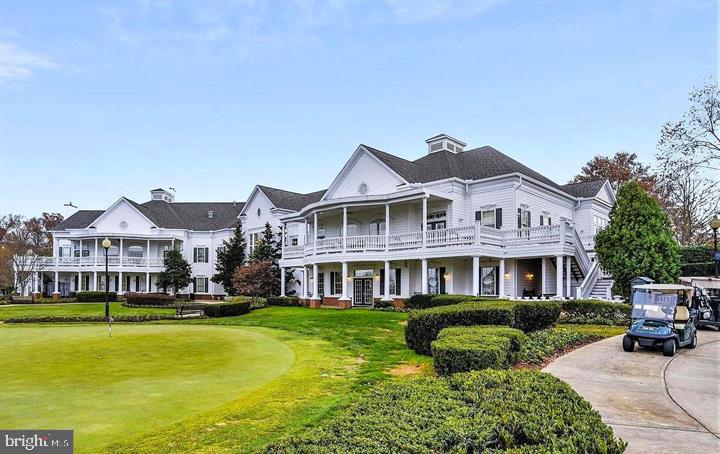 6013 Piney Grove Way Gainesville, VA 20155 - Photo 38 of 41 a front view of a building with a garden and lake view
