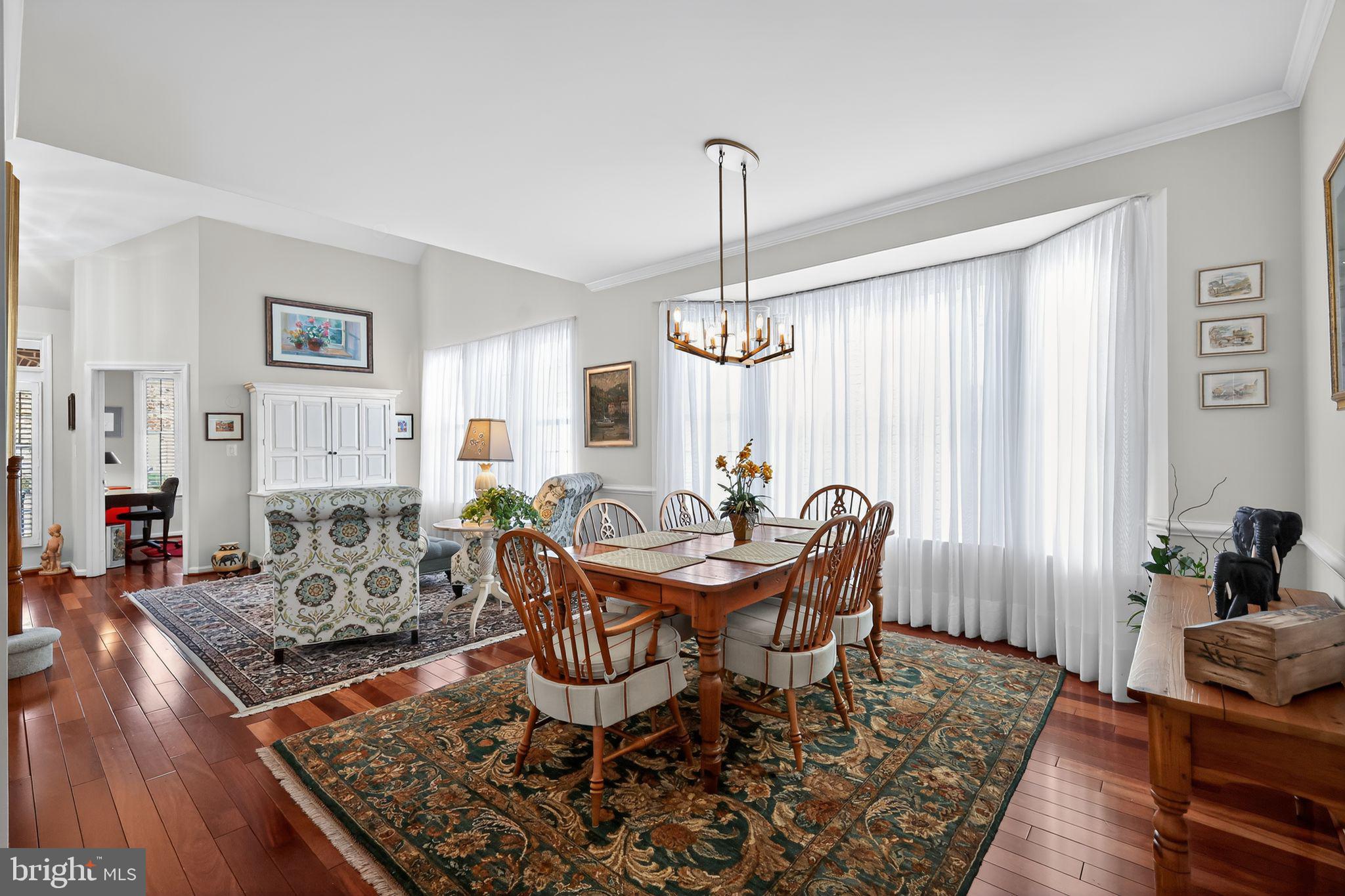 6013 Piney Grove Way Gainesville, VA 20155 - Photo 6 of 41 a view of a dining room with furniture window and wooden floor