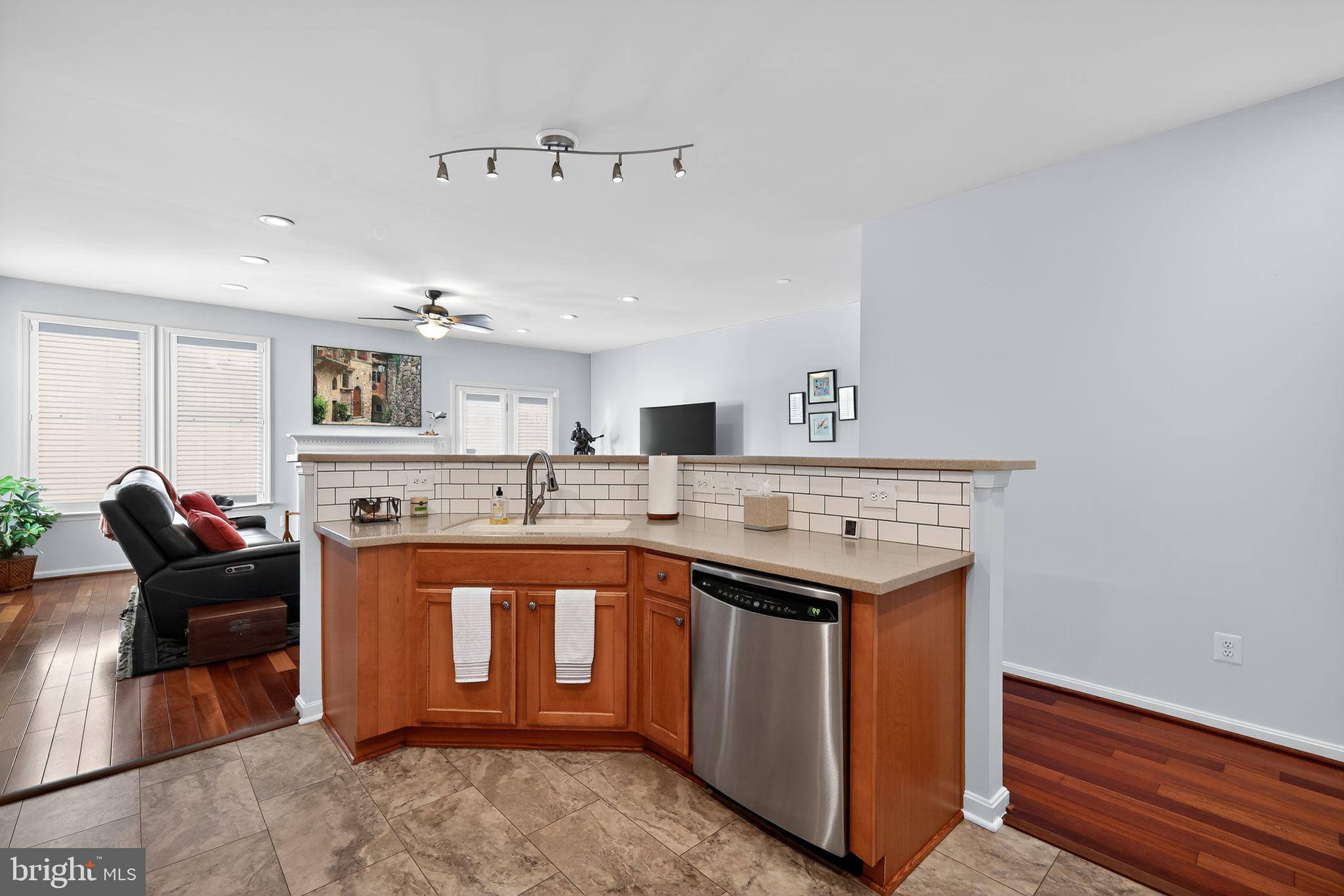 6013 Piney Grove Way Gainesville, VA 20155 - Photo 10 of 41 a kitchen with stainless steel appliances granite countertop a sink and a stove