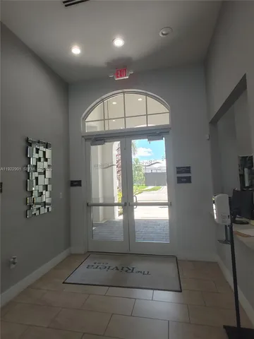 a kitchen with granite countertop a table chairs microwave and refrigerator