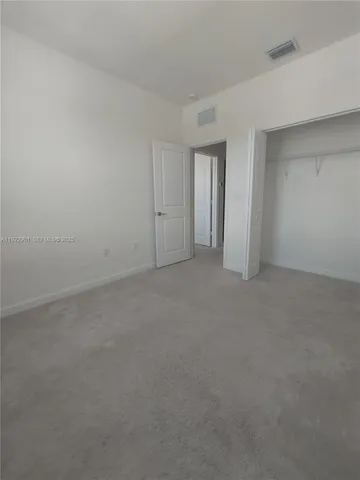 a view of an empty room and closet area