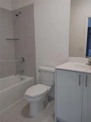 a white toilet sitting next to a bath tub